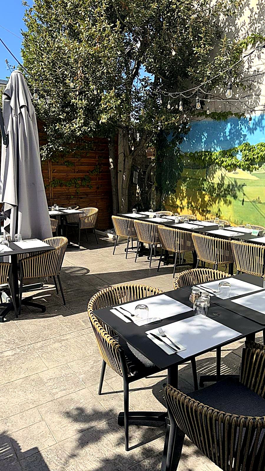 Tables dressées sur la terrasse ombragée de L'Authentique